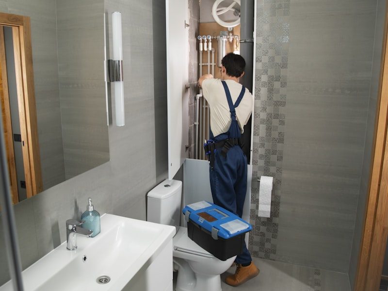 Plumber repairing the plumbing in a bathroom